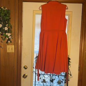 Size 10 smart looking sleeveless dress; orange. Length 40 inches.